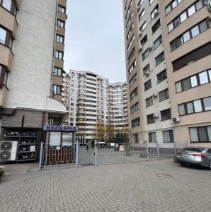 a fence in front of some tall buildings at Airport Transit Studio Ночь перед вылетом in Chişinău