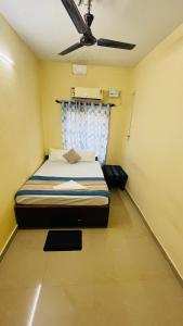 a bedroom with a bed and a ceiling fan at Arabian Shore - Udupi in Malpe