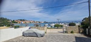 a mattress on a wall with a view of a harbor at Blue Pearl Seafront in Preko