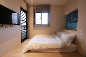 Voodi või voodid majutusasutuse Enjoy Homestay toas