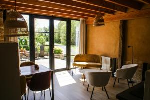 a living room with a table and chairs at vakantiewoning Odiel & Gabrielle in Montchevrier