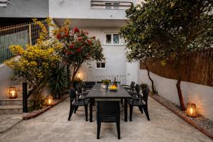 a table and chairs in a garden with lights at Charneca Mar & Sol in Charneca