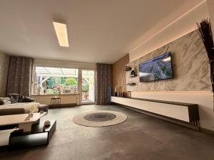 a large living room with a couch and a tv at Ferienwohnung W&S in Hettstedt