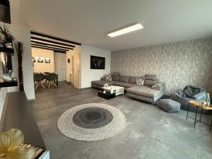 a living room with a couch and a table at Ferienwohnung W&S in Hettstedt