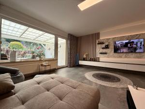 a living room with a couch and a large window at Ferienwohnung W&S in Hettstedt
