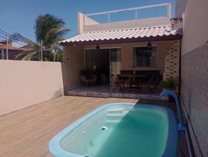 a hot tub on the deck of a house at Casa em Jauá in Camaçari