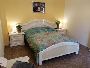 a bedroom with a bed and two night stands at Kitsch apartment in Rasquera +31 photos