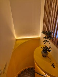 a stairway with a table with a plant on it at SoSi Stay in Seoul +59 photos