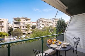 a table with food on top of a balcony at Charming Maisonette In Southern Suburbs in Athens