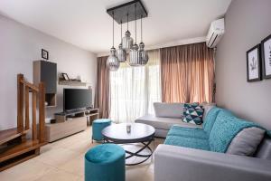 a living room with a couch and a table at Charming Maisonette In Southern Suburbs in Athens