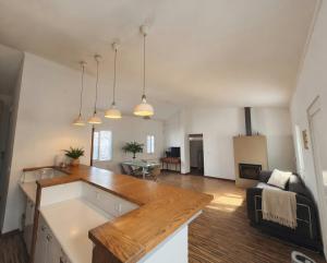 a kitchen and living room with a wooden counter top at Akistay Guest House - Caparica in Costa da Caparica