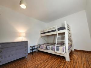 a white bunk bed in a room with a dresser at Akistay Guest House - Caparica in Costa da Caparica