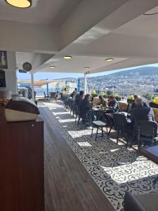 a restaurant with people sitting at tables with a view at Hotel Efesian B&B City Center - Harbour in Kuşadası