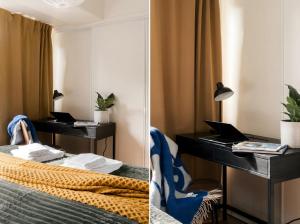 a bedroom with a desk and a bed with a laptop at Guestly Homes - Central Premium Suite 1BR in Västerås