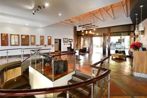 a lobby with a staircase in a building at Elements Private Golf Reserve 109 in Moheme +69 photos