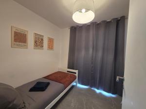 a small bedroom with a bed with a blue light at Flexi flat Gosselies Providence 12 in Charleroi