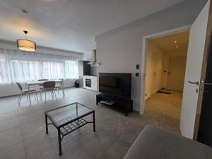 a living room with a table and a dining room at Flexi flat Gosselies Providence 12 in Charleroi