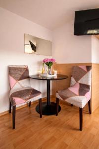 a dining room with a table and two chairs at Bled Vista Apartments in Bled