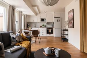 a living room with a couch and a table at Guestly Homes - Central Premium Studio in Västerås