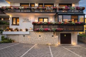 a building with flower boxes on top of it at Bled Vista Apartments in Bled
