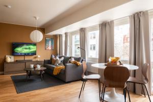a living room with a couch and a table at Guestly Homes - Central Premium Studio in Västerås