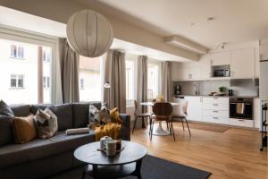 a living room with a couch and a table at Guestly Homes - Central Premium Studio in Västerås +38 photos