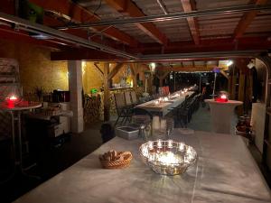 a long table in a restaurant with candles on it at Ferien-Landleben in Löbnitz