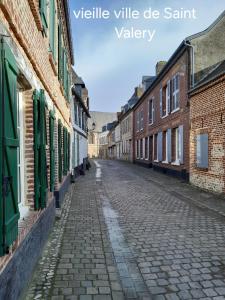 an empty cobblestone street in an old town at Gîte du Bois de Drancourt in Drancourt