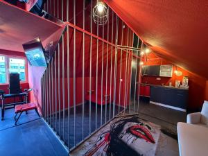 a staircase in a room with a red wall at Intimissima apartman in Odorheiu Secuiesc