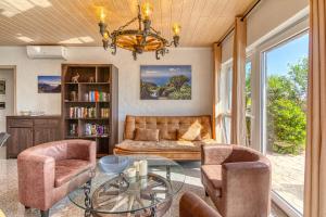 a living room with a couch and chairs and a glass table at Hotel Rural Los Piratas in Tijarafe +228 photos