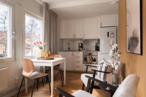 a kitchen and dining room with a table and chairs at Guestly Homes - Central Smart Studio in Västerås +51 photos