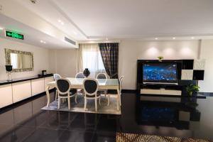 a dining room with a table and a tv at AlAshrafia Smart Residence in Cairo +17 photos