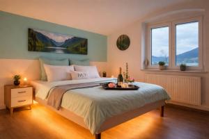 a bedroom with a large bed and two windows at Bled Vista Apartments in Bled