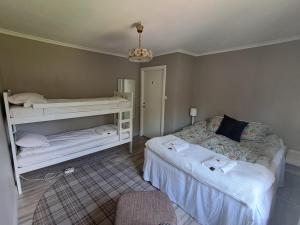 a small bedroom with two beds and a chandelier at Ankis i Virserum in Virserum +19 photos