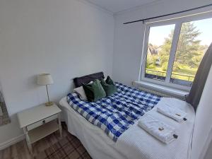 a small bedroom with a bed and a window at Ankis i Virserum in Virserum