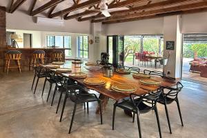 a large dining room with a large wooden table and chairs at Elements Private Golf Reserve 109 in Moheme