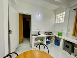 a kitchen with a wooden table in a room at Elegant Mist Villa in Nuwara Eliya