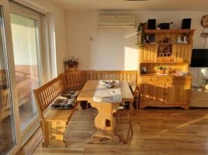 a room with a wooden table and a table and a dining room at Vineyard Cottage with Private Jacuzzi in Metlika +30 photos