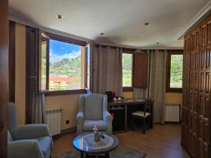 a room with a desk and chairs and a large window at Hosteria Picos De Europa in Potes +203 photos
