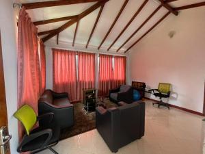 a living room with couches and chairs at Elegant Mist Villa in Nuwara Eliya