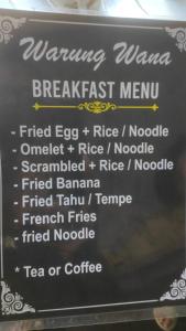 a sign for a breakfast menu in a restaurant at Wana Wooden House in Munduk