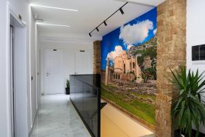 a hallway with a wall mural of a building at Villa Mefaja in Krujë