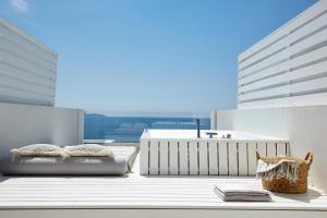 a balcony with two beds and a tub on a building at Lichnos Beach in Parga