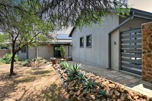 a house with a garage and a yard at Elements Private Golf Reserve 109 in Moheme