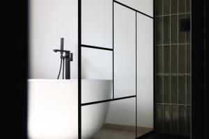 a bathroom with a white sink and a mirror at Escale Doullennaise - Appartement neuf avec terrasse in Doullens +24 photos