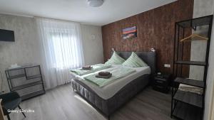 a bedroom with a large bed and a window at Pension Hendriks in Cochem