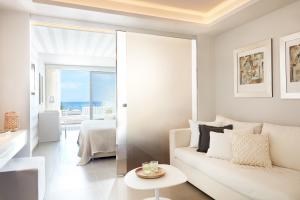 a living room with a white couch and a view of the ocean at Lichnos Beach in Parga