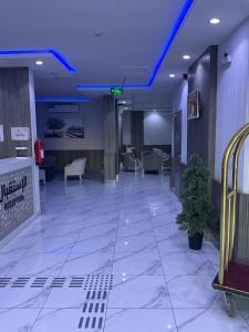 a lobby with a blue ceiling in a hospital at فندق اجنحه البيداء فرع2 AlBaydaa Suites Hotel Branch in Medina
