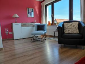 a living room with a chair and a refrigerator at Ferienwohnung Twete in Detmold