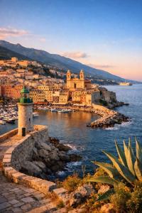 a view of a town on the water with a lighthouse at Triplex Hyper Centre Bastia Direct Musée et Citadelle in Bastia
